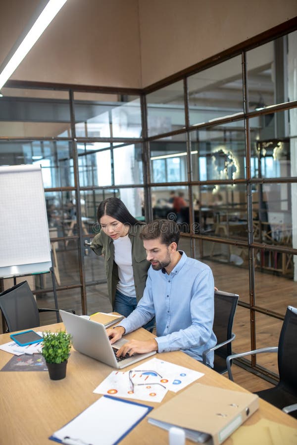Young manager and his assistant working together in the office royalty free stock photo
