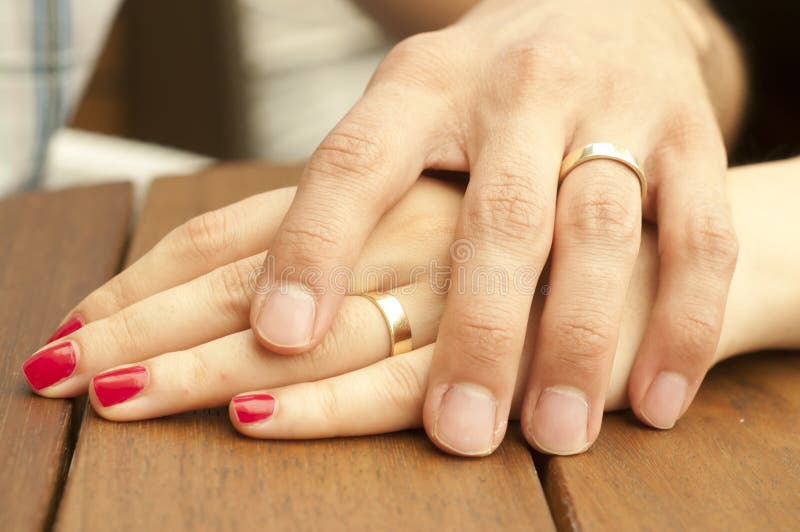 Young Married Couple Holding Hands Closeup