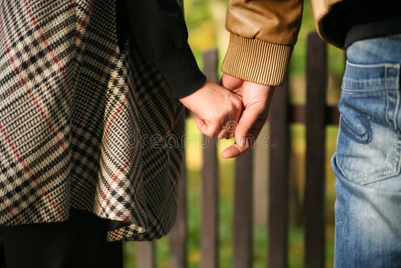 Young married couple holding hands stock images