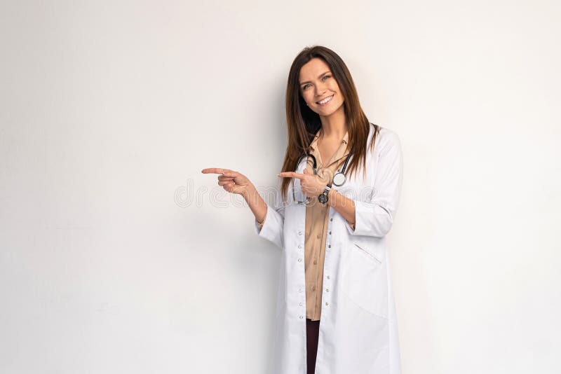 Young medical doctor woman presenting and showing copy space for product or text. Caucasian female medical professional