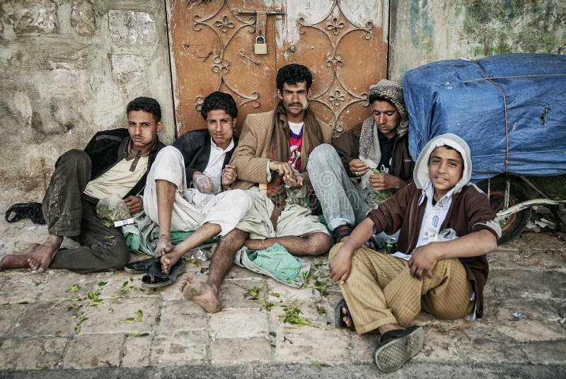 Young arab men chewing khat qat narcotic drug leaves in sanaa yemen street. Young arab men chewing khat qat narcotic drug leaves in sanaa yemen street