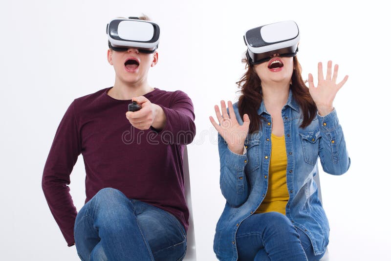 Young man and woman in casual clothes in virtual goggles, vr isolated on white background. Technology and innovation concept. stock photo Young man and woman in casual clothes in virtual goggles, vr isolated on white background. Technology and innovation concept. stock photo