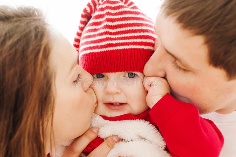 Parents Kissing Baby in Cheeks Stock Image - Image of feelings, love:  124274835