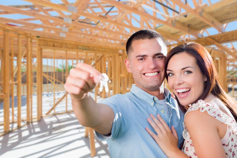 Young Military Couple On Site With House Keys Inside Their New H