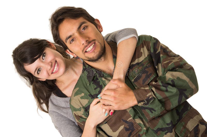 Young military soldier returns to meet his wife girlfriend hugging isolated on white