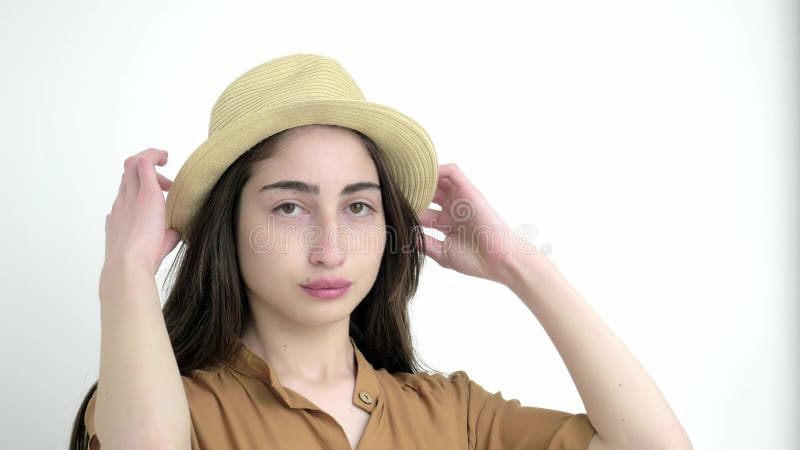 Young model girl in Studio white background. close up beautiful caucasian lady in hat looks at camera