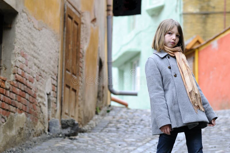 Young model posing with old houses in background