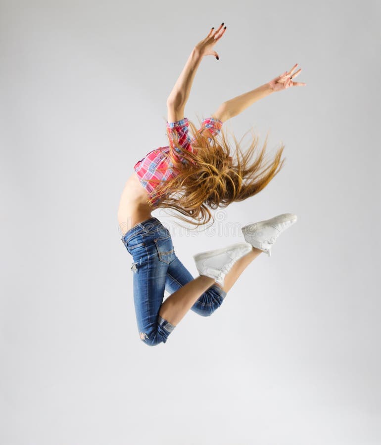 Young modern dancing girl in jeans