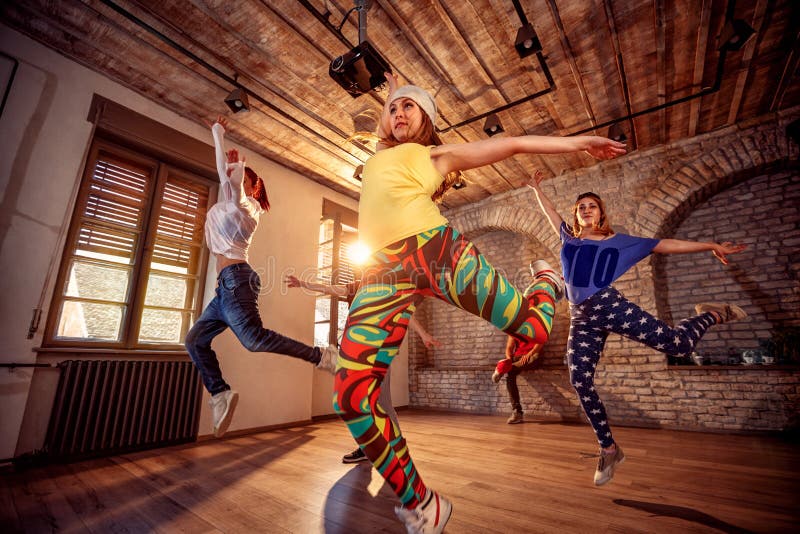 Young modern hip hop dancing girls in urban fitness center