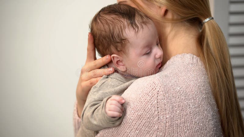 Young mom holding cute baby boy in arms, vaginal birth and natural motherhood royalty free stock images Young mom holding cute baby boy in arms, vaginal birth and natural motherhood royalty free stock images