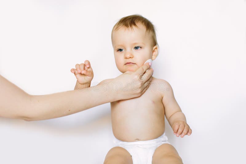 Young Mom Wiping the Baby Skin Body and Face with Wet Wipes Carefully on White Background. Concept Cleaning Wipe, Pure Stock Image - Image of beauty, face: 160911369 Young Mom Wiping the Baby Skin Body and Face with Wet Wipes Carefully on White Background. Concept Cleaning Wipe, Pure Stock Image - Image of beauty, face: 160911369