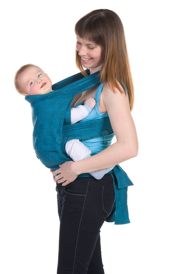 Young mother with baby in sling laughing