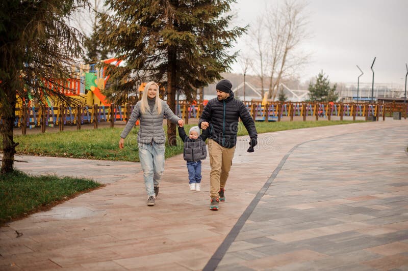 Young mother and father walking with a little son royalty free stock photography Young mother and father walking with a little son royalty free stock photography