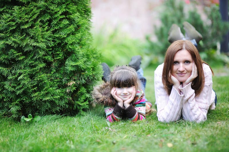 Young mother with her daughter in the garden