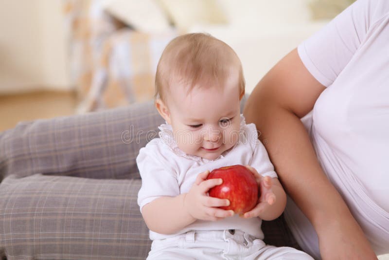 A young mother with her infant baby at home