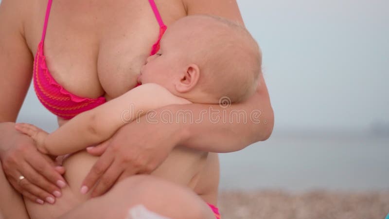 Young Mother Holding Baby. Mom Breastfeeding Infant during Relax on Seaside Stock Footage - Video of breast, feeding: 138112540