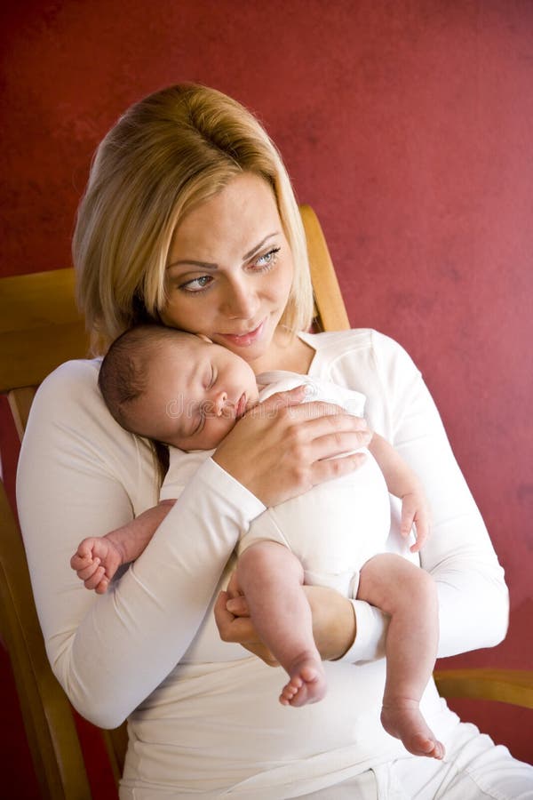 Young mother holding newborn baby boy in arms royalty free stock photography Young mother holding newborn baby boy in arms royalty free stock photography