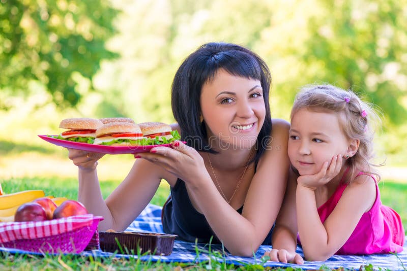 Young Mother Holding A Plate With Burgers