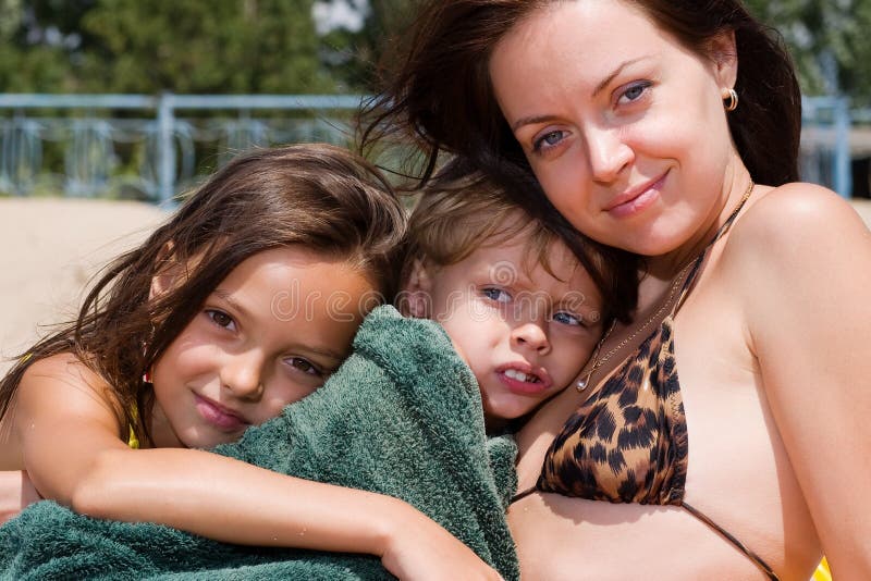 Young mother with kids at the summer resort