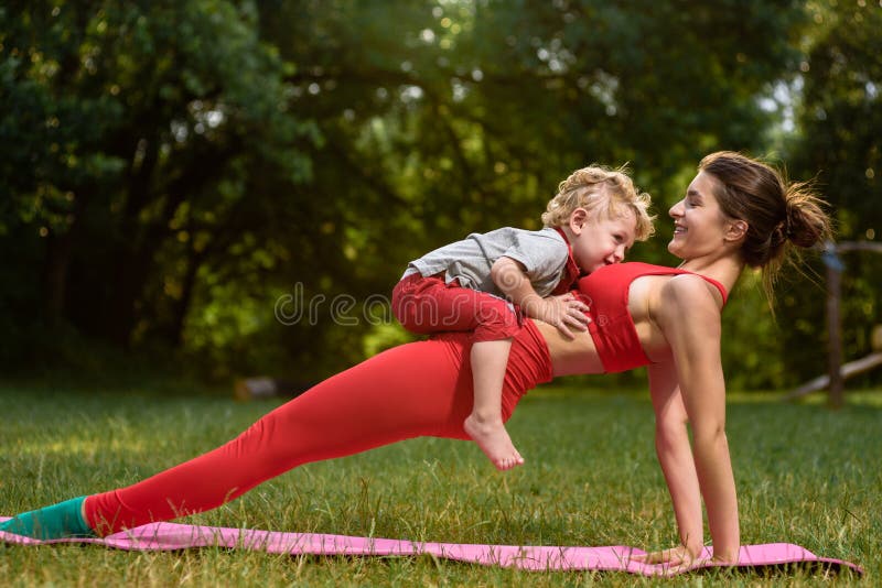 Woman exercising with son.
