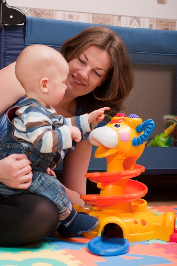 Young mother playing with baby boy