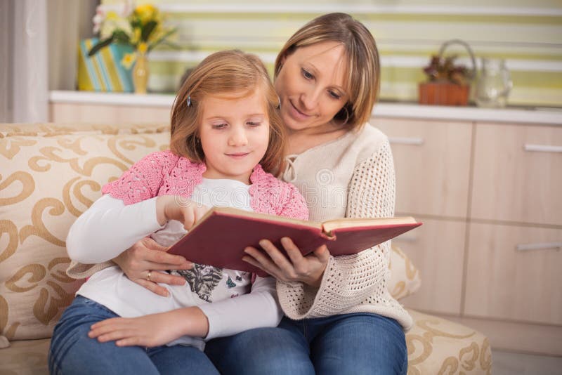 Молодая мама читать. Мама читает книжку ребенку. Красивая мама читает книгу с ребенком. Мама читает книгу девочке. Дети с книжкой на кровати с родителями.