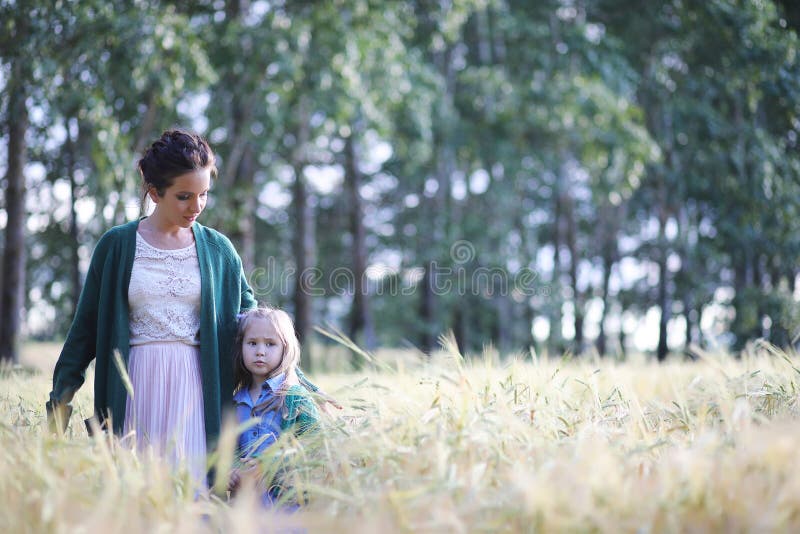 A young mother walk in wheat fields stock image A young mother walk in wheat fields stock image