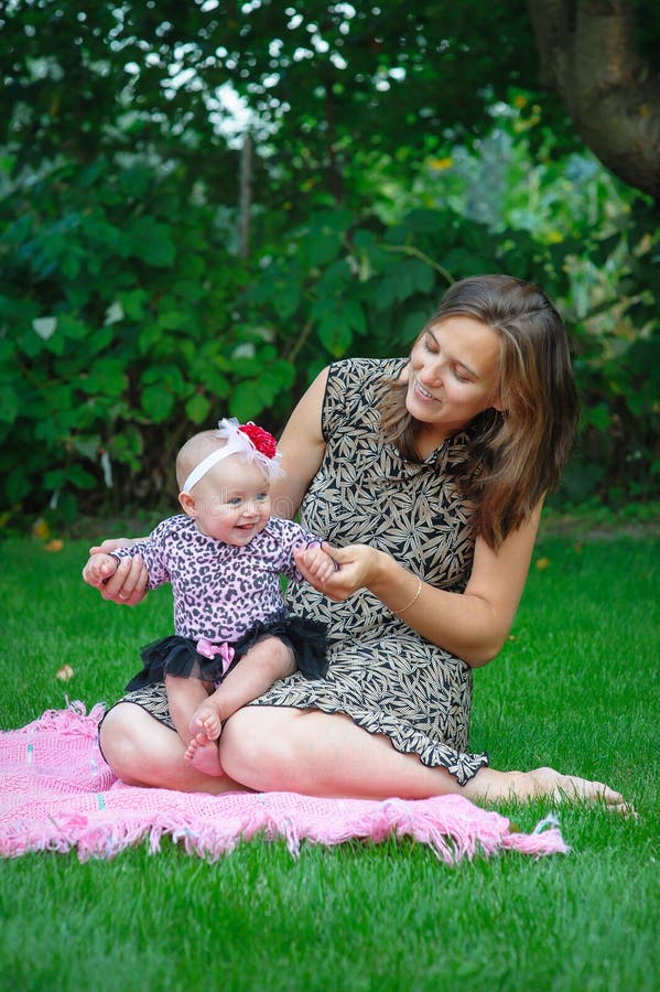 Mom And Daughter Playing On Green Grass In A Meadow And Text Day In The Life Calligraphy