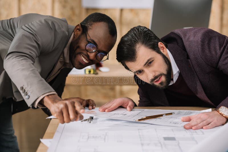 Young multiethnic architects discussing royalty free stock images