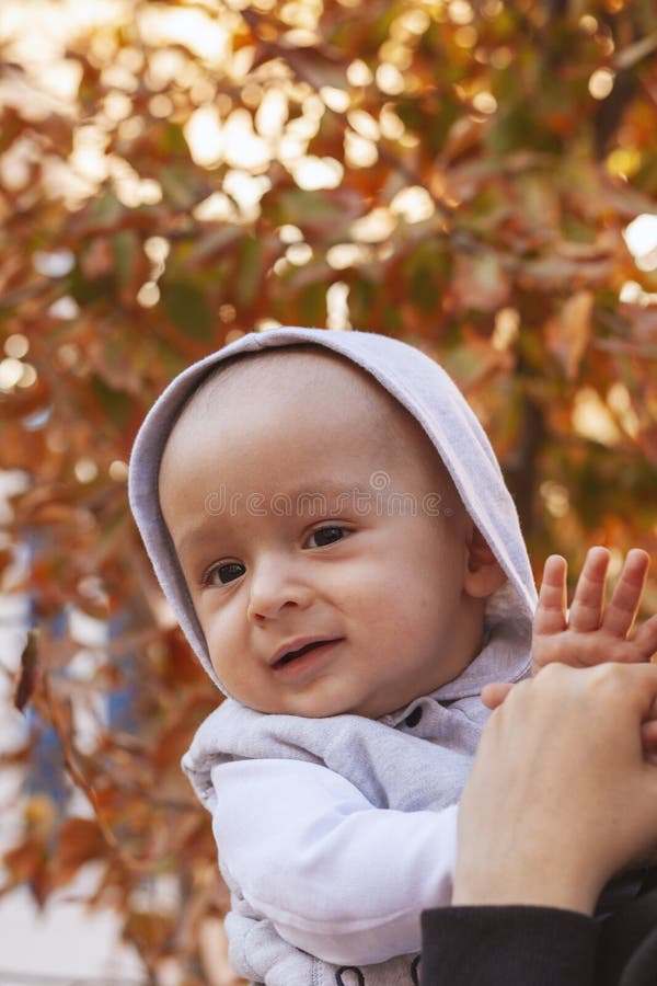 Young Muslim woman in hijab holding her 1-year-old baby boy, hugging and kissing. Happy Muslim mother in abaya clothing kiss and royalty free stock photos Young Muslim woman in hijab holding her 1-year-old baby boy, hugging and kissing. Happy Muslim mother in abaya clothing kiss and royalty free stock photos