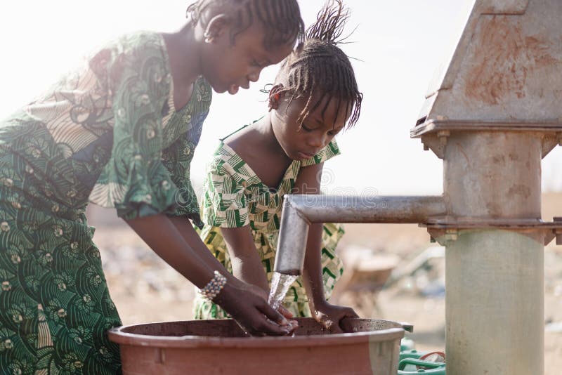 Young Native African Infant Saving Crisp Water for a lack of water symbol royalty free stock image