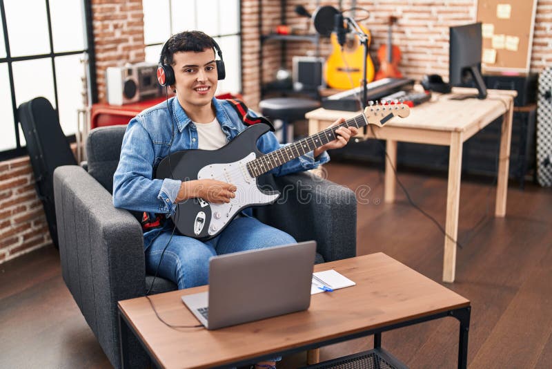 Young Non Binary Man Musician Having Online Electric Guitar Lesson at