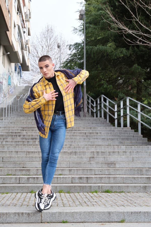 Young non binary person dancing in the street royalty free stock image