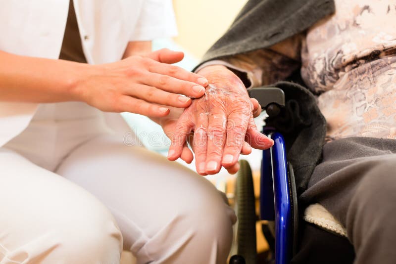 Young nurse and female senior in nursing home, the old lady sitting in a wheel chair