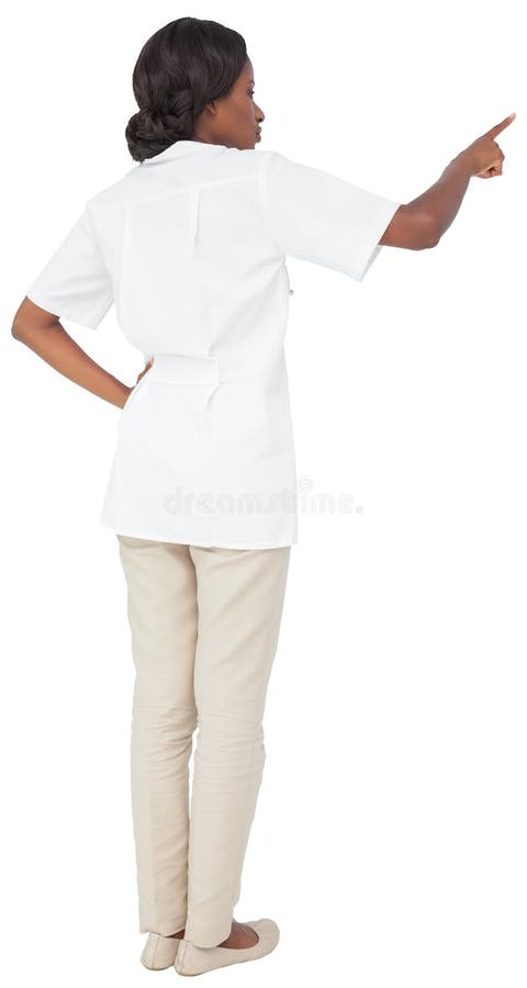 Young nurse in tunic pointing