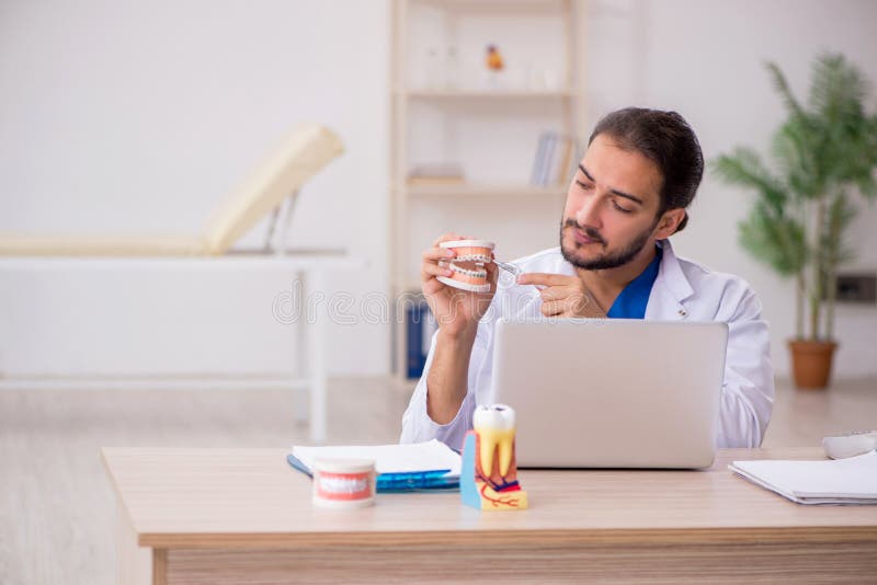 Young male odontologist in telemedicine concept