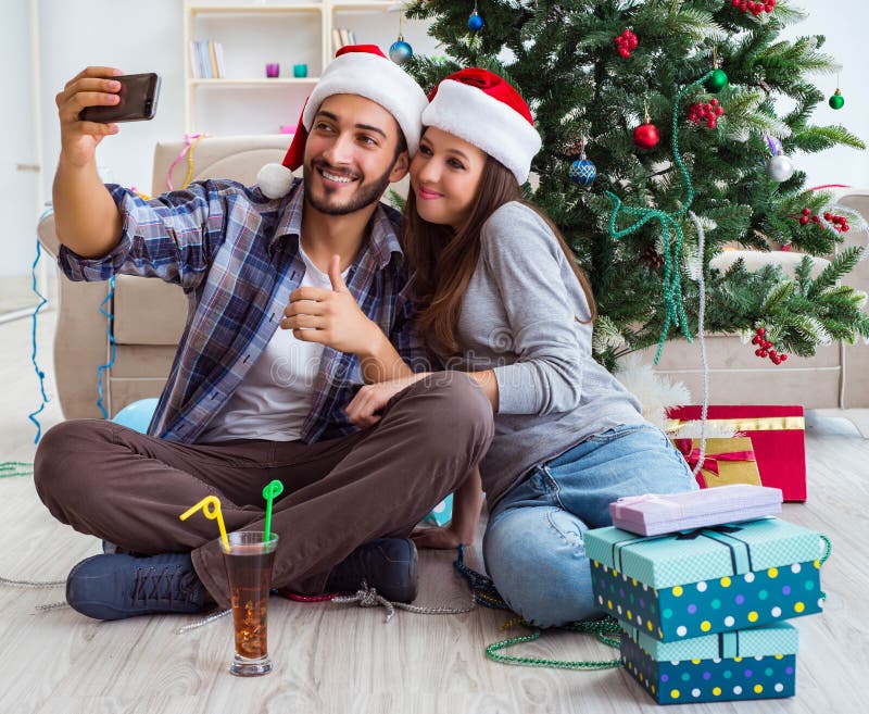 Young Pair Taking Selfies during Christmas Stock Photo - Image of home ...