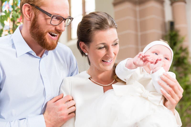 Parents with baby at christening in church