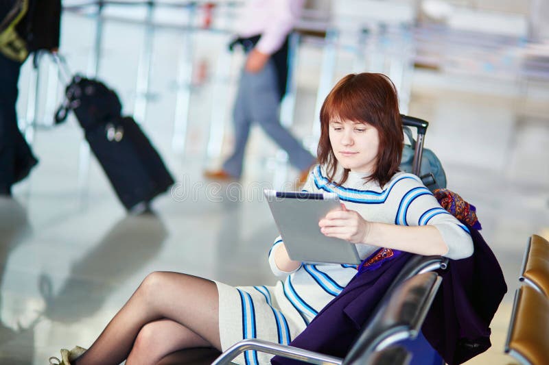 Young Passenger at the Airport, Using Her Tablet Stock Photo Image of international, baggage