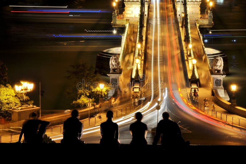 Young people at Chain bridge of Budapet at night