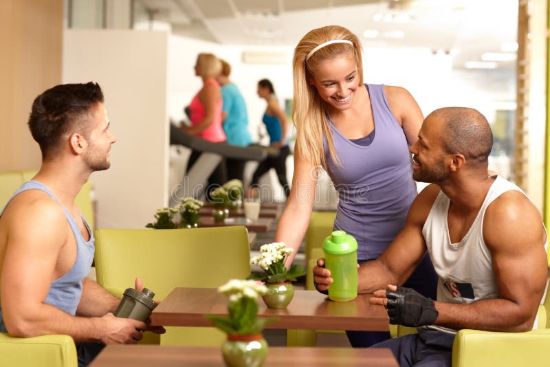 Young people chatting in gym bar