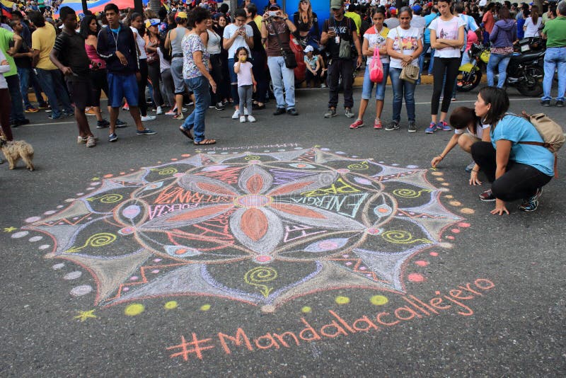 Young people drawing mandala for love and peace in the streets of Caracas during Venezuela blackout royalty free stock photo Young people drawing mandala for love and peace in the streets of Caracas during Venezuela blackout royalty free stock photo