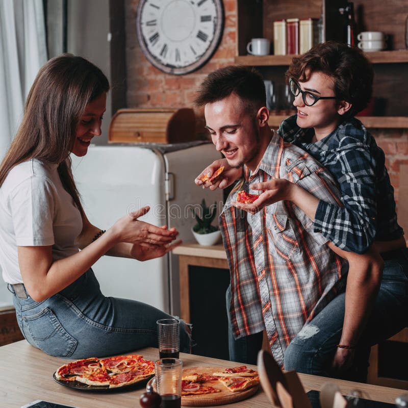 Group Of Friends Eating Pizza Together At Home Stock Photo, Picture and  Royalty Free Image. Image 56950664.