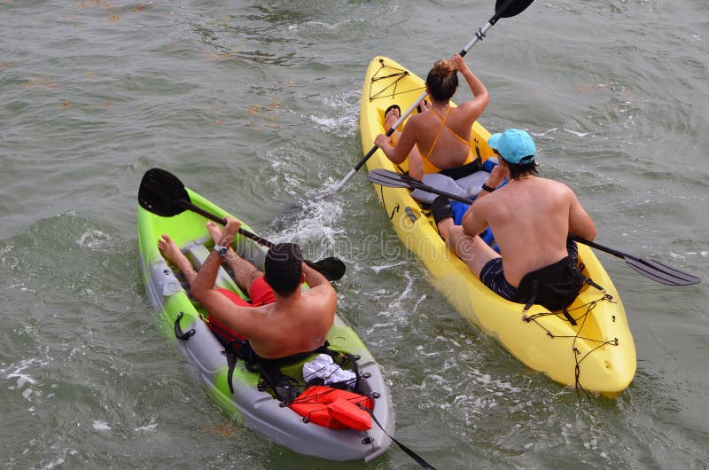 Sunset Harbor Kayakers. Young people enjoying an outing on Biscayne Bay in to inflatable kayaks, Harbor Kayakers stock photo