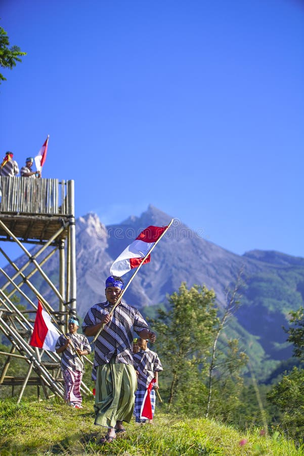 Young People with Flag. Indonesia Flag, Indonesia Independance Day with mt Merapi background royalty free stock photography Young People with Flag. Indonesia Flag, Indonesia Independance Day with mt Merapi background royalty free stock photography