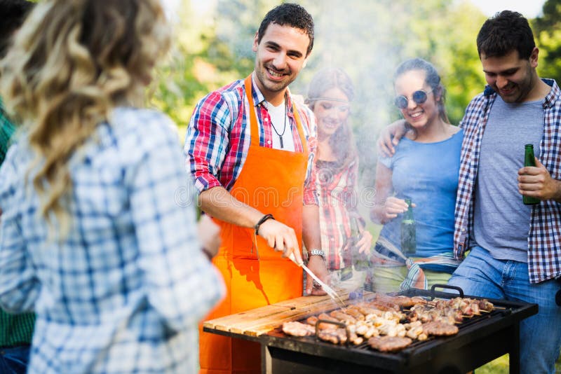 Young People Grilling Outdoors Stock Photo Image of barbecue