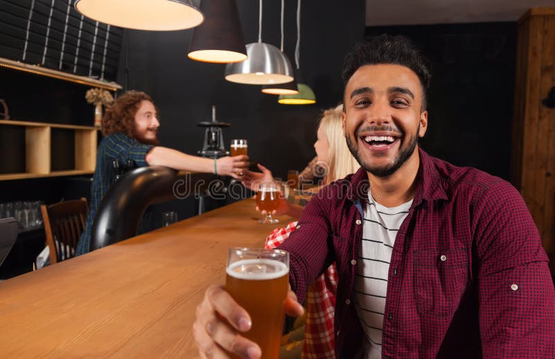 Young People Group in Bar, Hispanic Man Hold Glass Toasting Happy ...