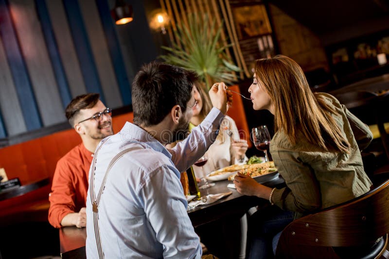 Young People Having Dinner in the Restaurant Stock Image - Image of