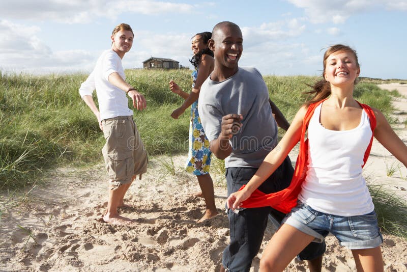 Young People Having Fun Dancing On Beach