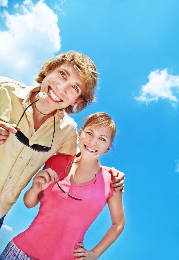 Cheerful friends in the summer on a background sky. young people having fun outdoors